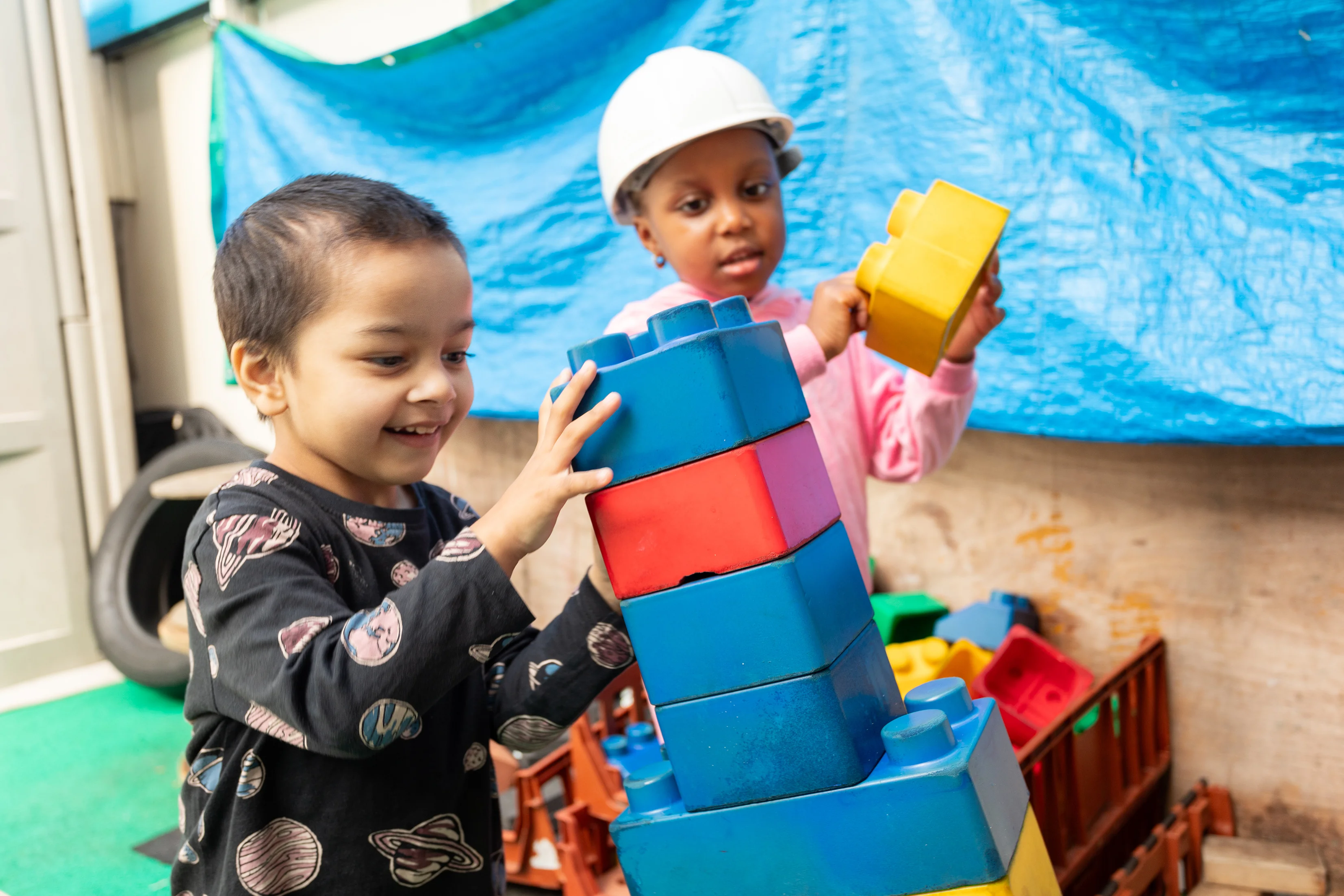 Young children playing with building blocks