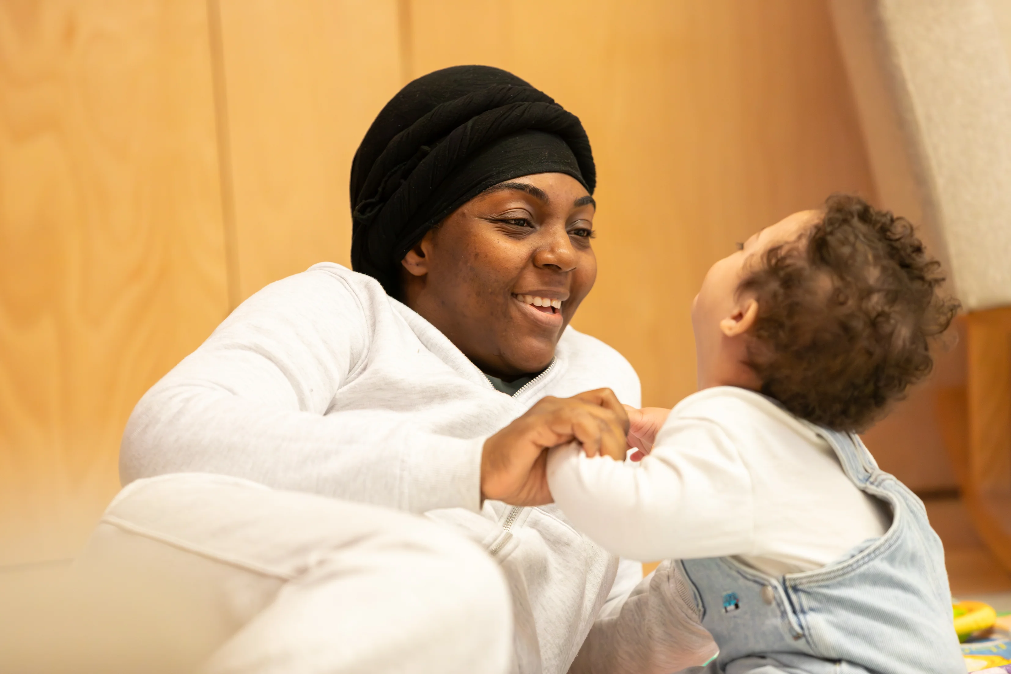 A childcare worker plays with a young child.